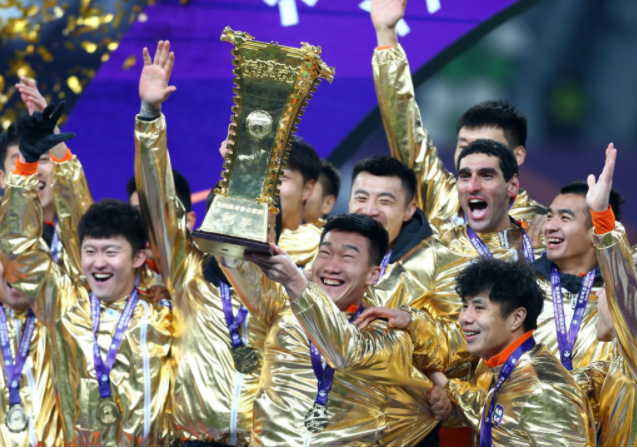 12月19日，山东鲁能泰山队球员在颁奖仪式上捧杯庆祝